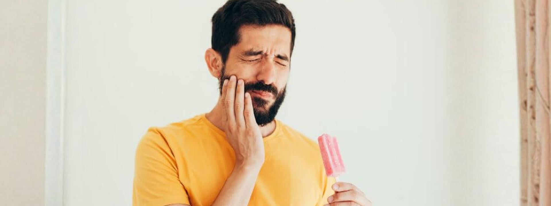 Man with tooth sensitivity to ice cream.